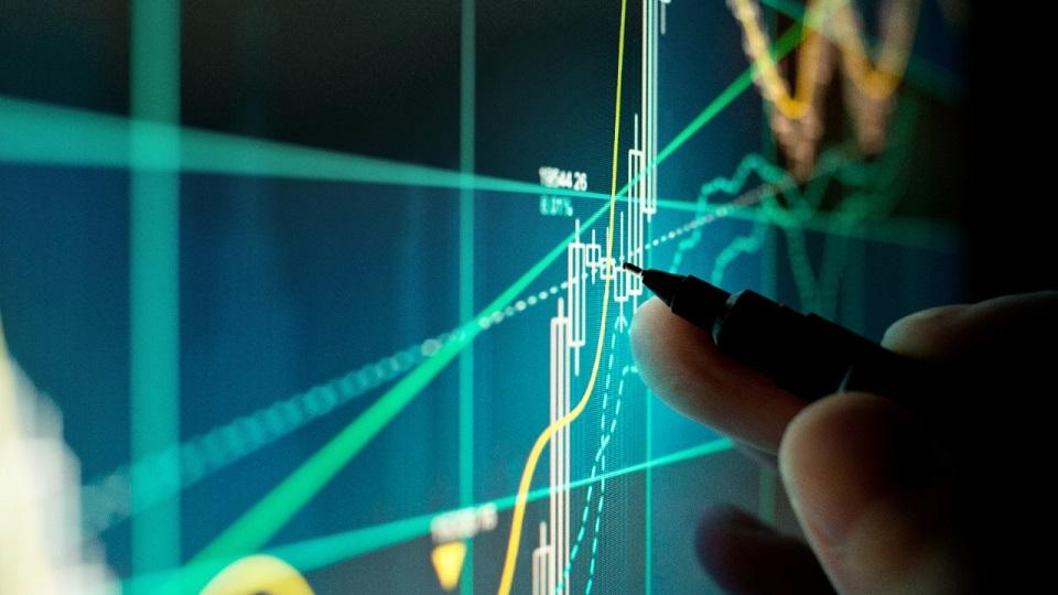 A Stock Trader Checking Chart Fundamentals - A stock trader checking technical markers of a stock on a computer screen.